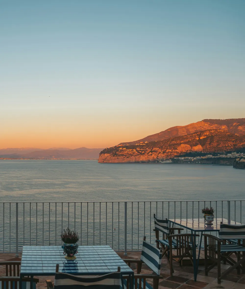 Terrace tables overlooking the Bay of Naples at sunset, Sorrento